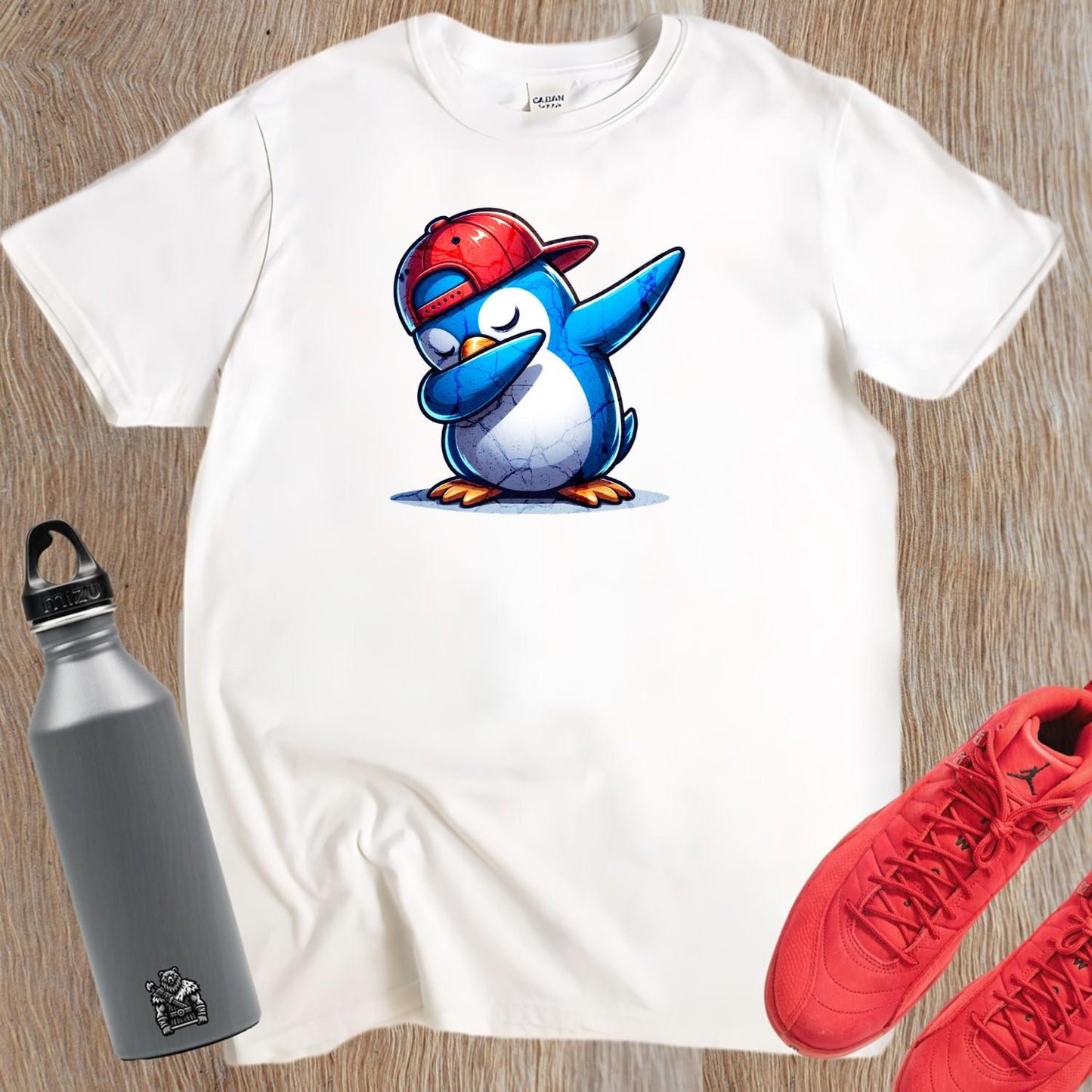 "Vibrant penguin-themed gym tee featuring a cartoon penguin in a snapback, perfect for fun workouts and casual outings."
