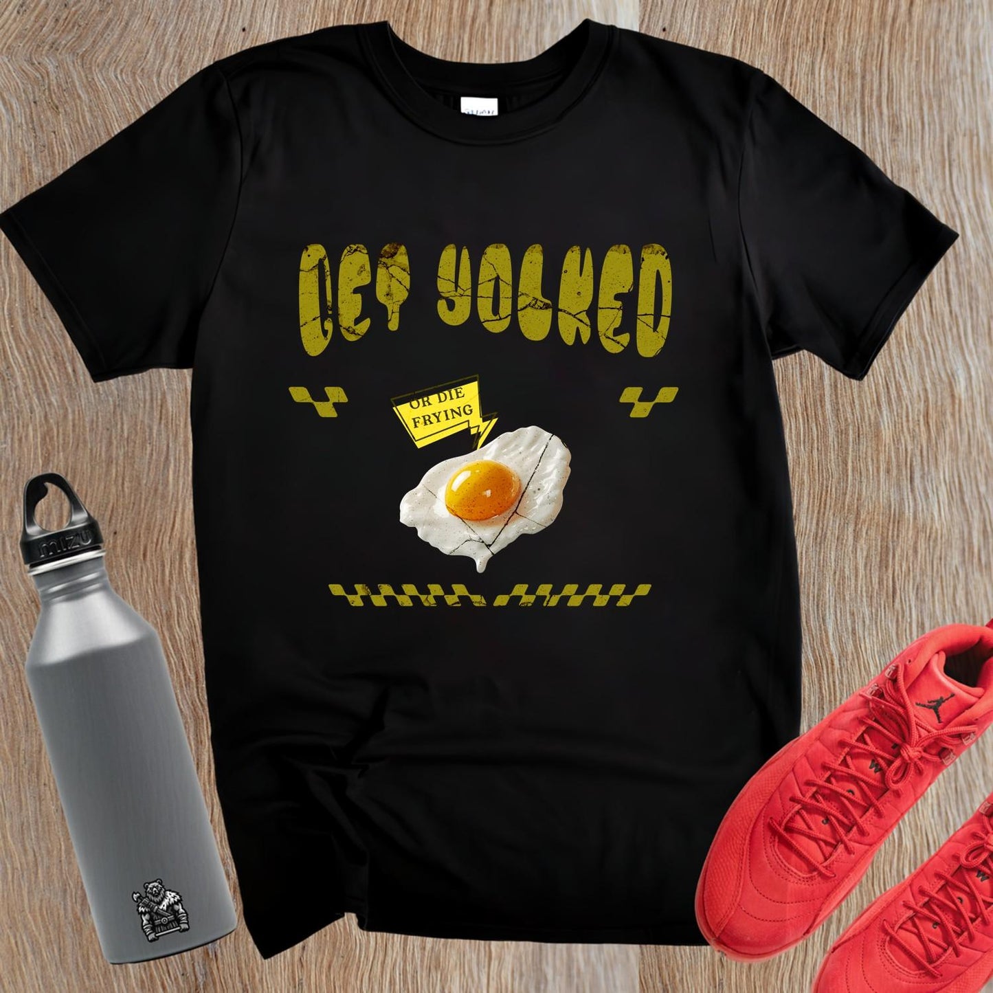 "Bold 'Get Yolked' T-shirt featuring a playful fried egg design, perfect for gym workouts or casual outings. Fitness fashion statement."