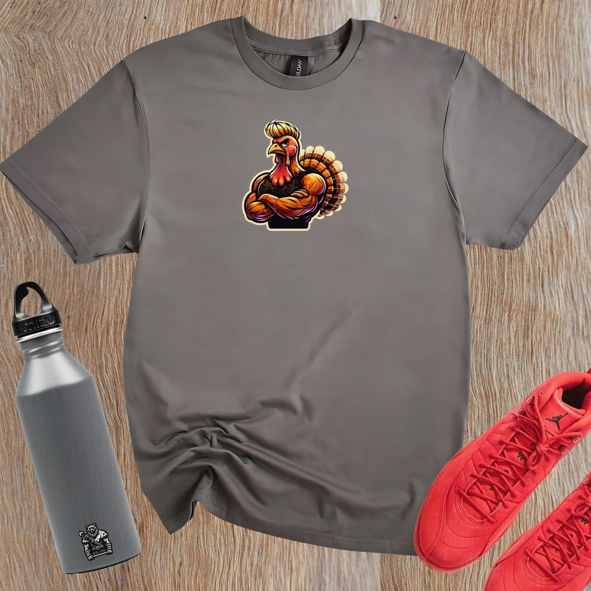 "Muscular turkey graphic on a bold workout T-shirt, blending humor and fitness, perfect for gym lovers wanting unique style."