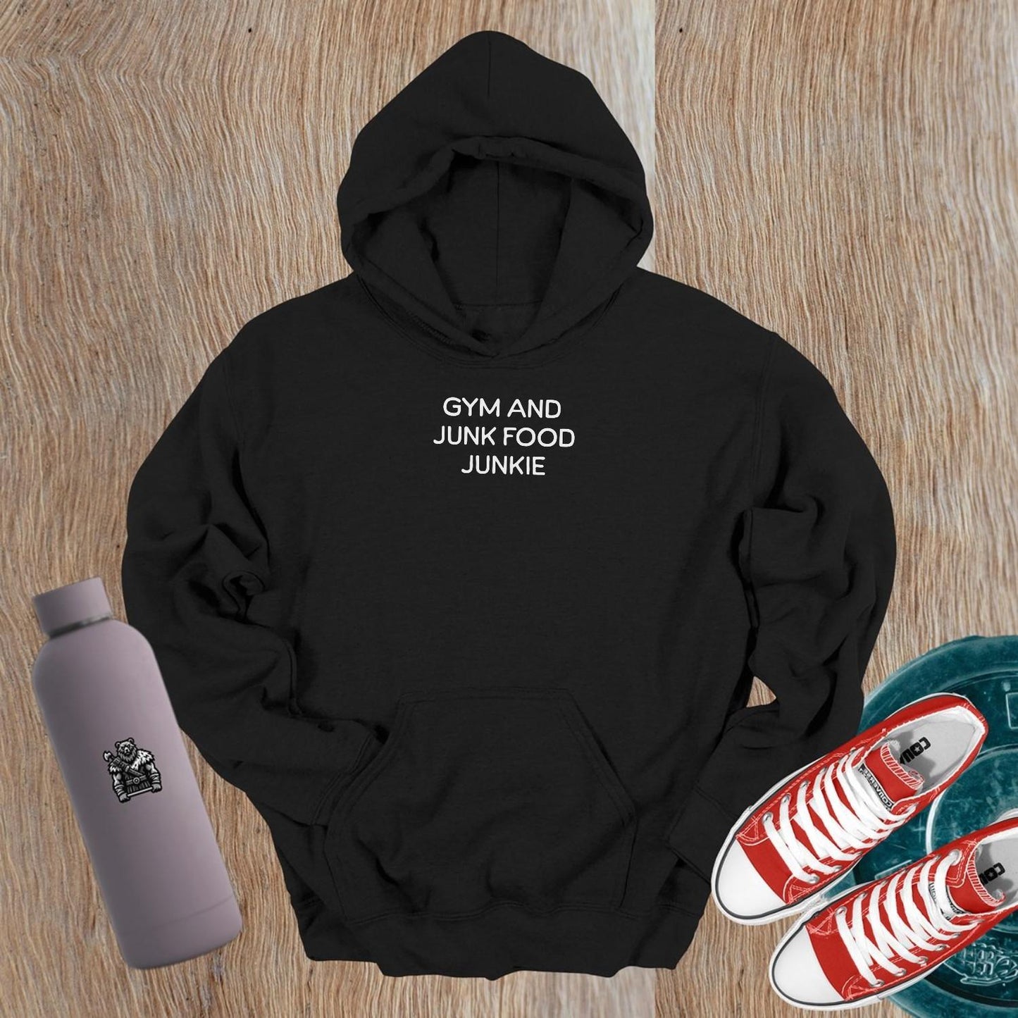 "Stylish 'Gym and Junk Food Junkie' hoodie featuring bold text, perfect for fitness lovers balancing workouts and indulgent treats."