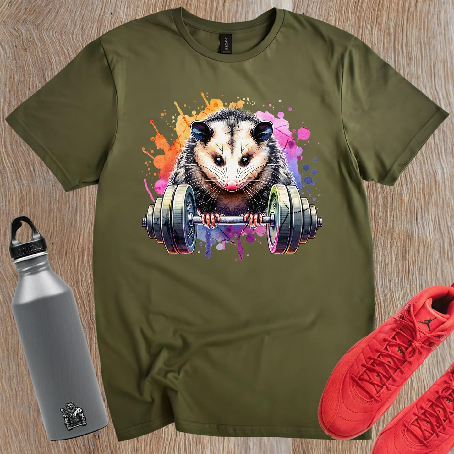 "Vibrant gym T-shirt featuring a playful opossum lifting weights, blending fitness and fun, perfect for workout enthusiasts."