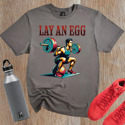 "Graphic gym T-shirt featuring 'Lay An Egg' design, showcasing humor in fitness. Ideal for workouts, casual outings, and style."