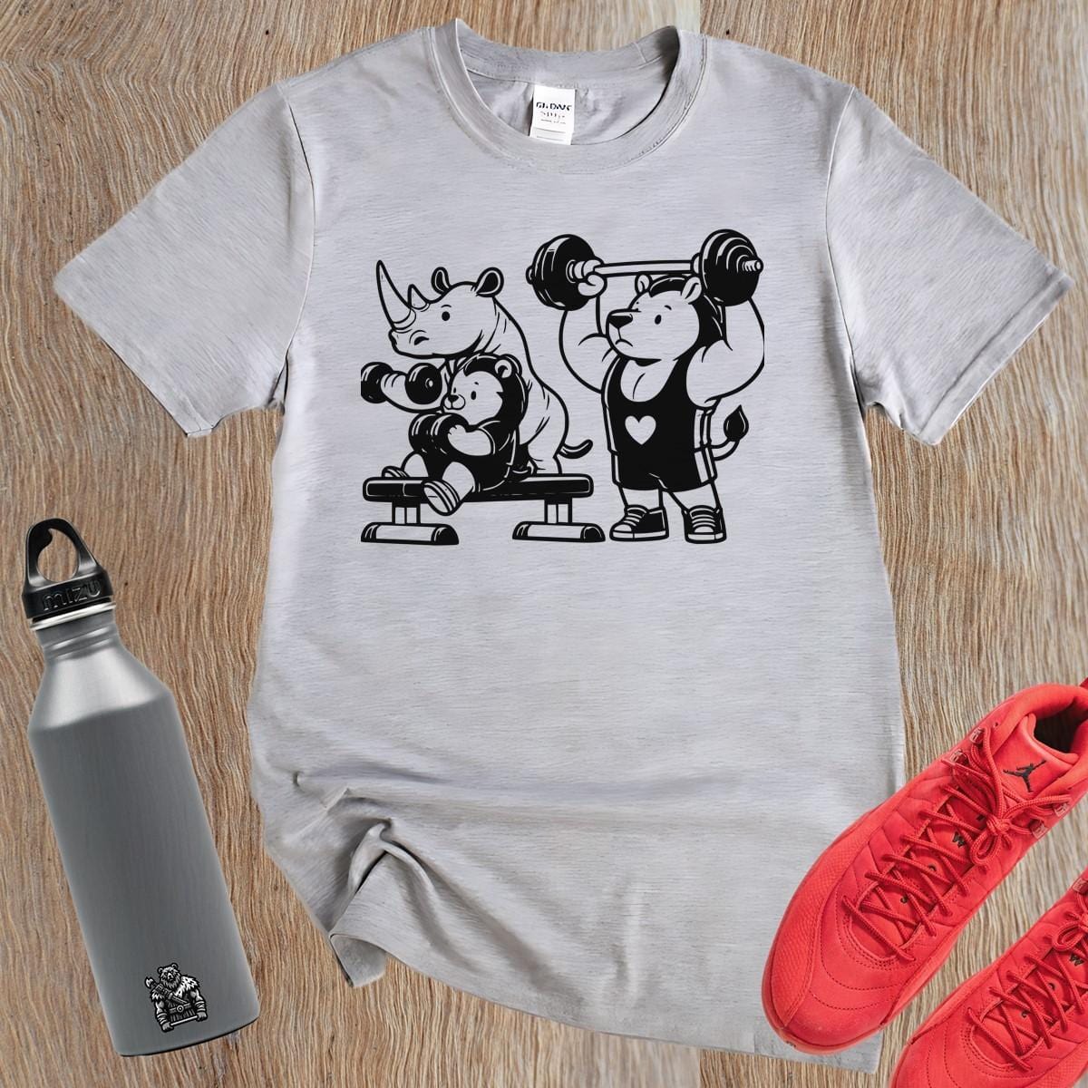 "Playful gym T-shirt featuring a trio of fitness-loving animals, combining fun and comfort for gym enthusiasts and workout motivation."