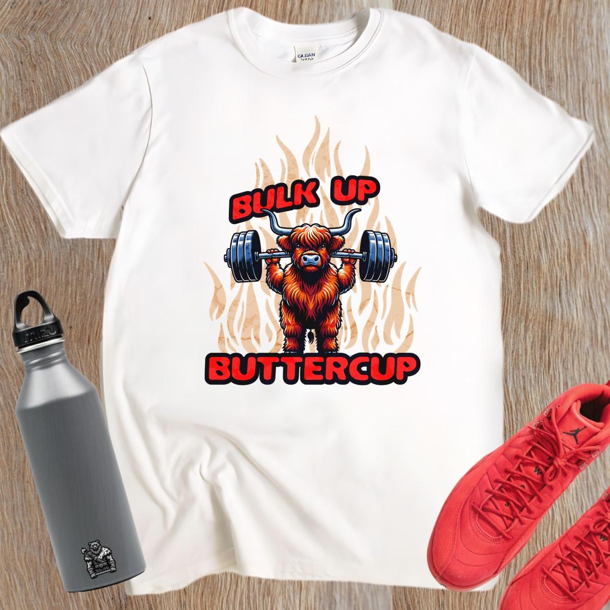 Alt text: "Bulk Up Buttercup T-shirt featuring a fierce weightlifting Highland cow surrounded by vibrant flames, perfect for gym enthusiasts."