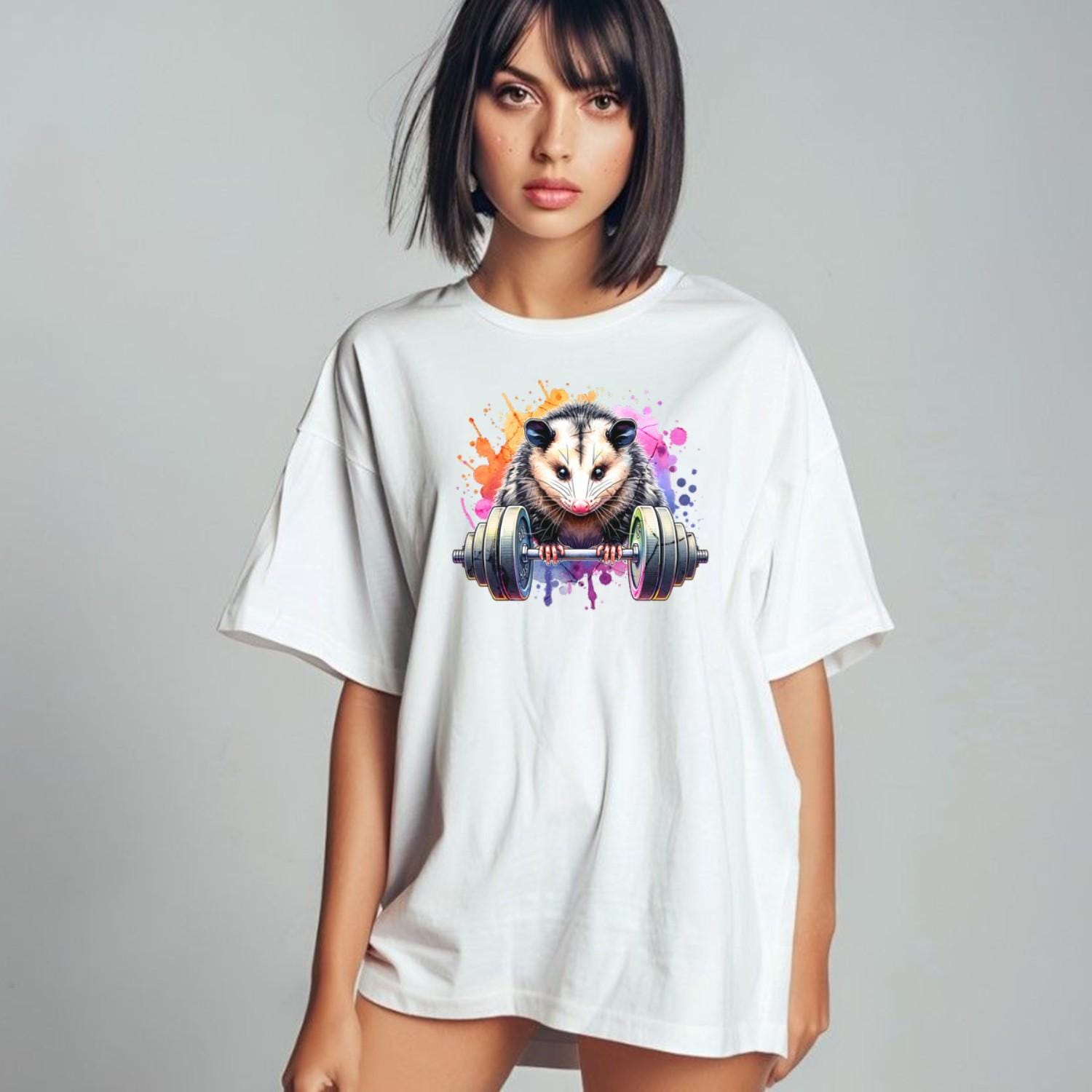 "Vibrant gym T-shirt featuring a fierce possum lifting weights, embodying strength and determination for fitness enthusiasts."