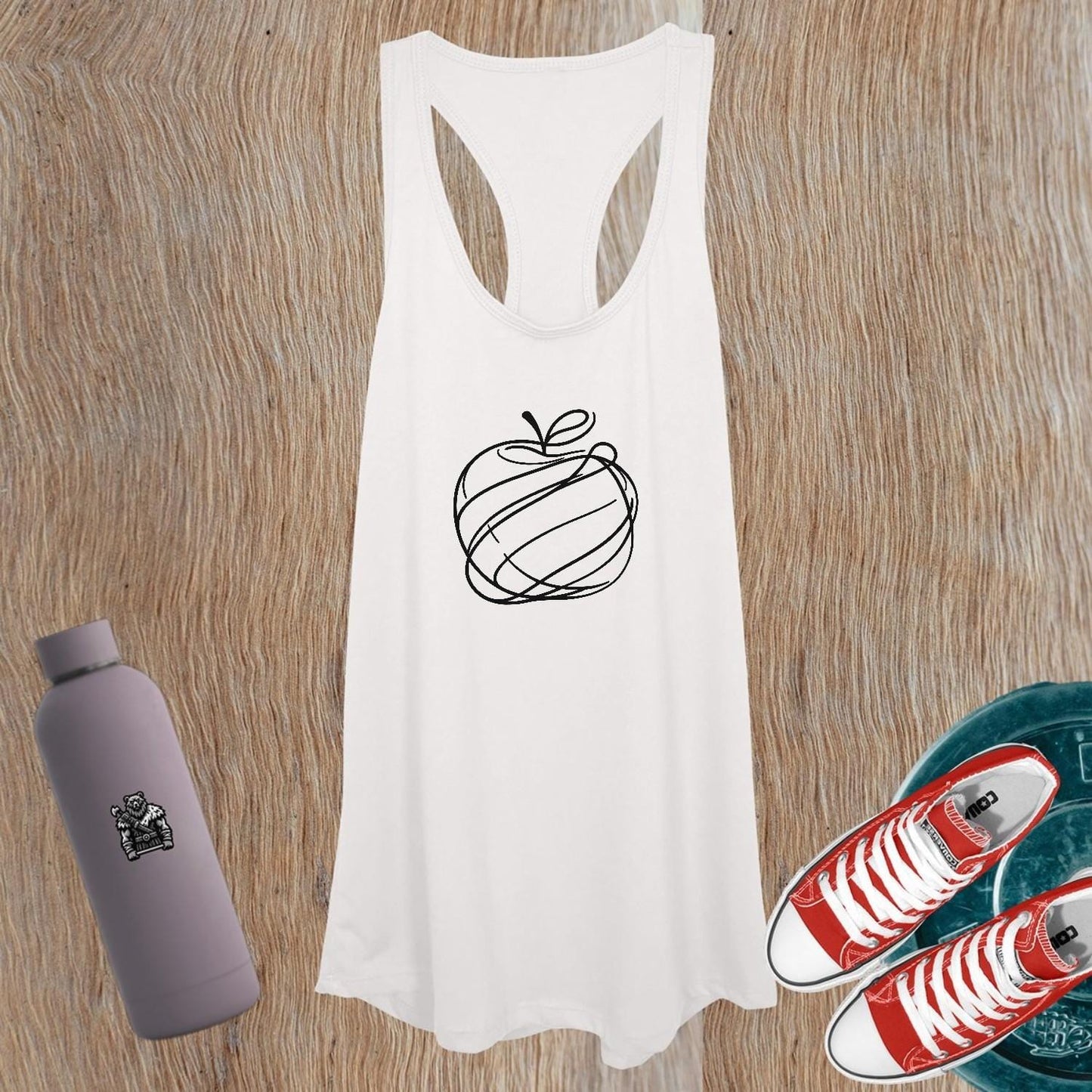 "Vibrant women's tank top featuring a playful apple design, perfect for workouts and casual outings, combining style and comfort."