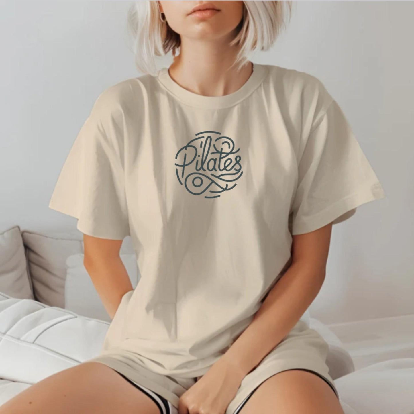 Stylish Pilates T-shirt featuring a modern logo, tailored for comfort and movement, ideal for workouts and casual outings.