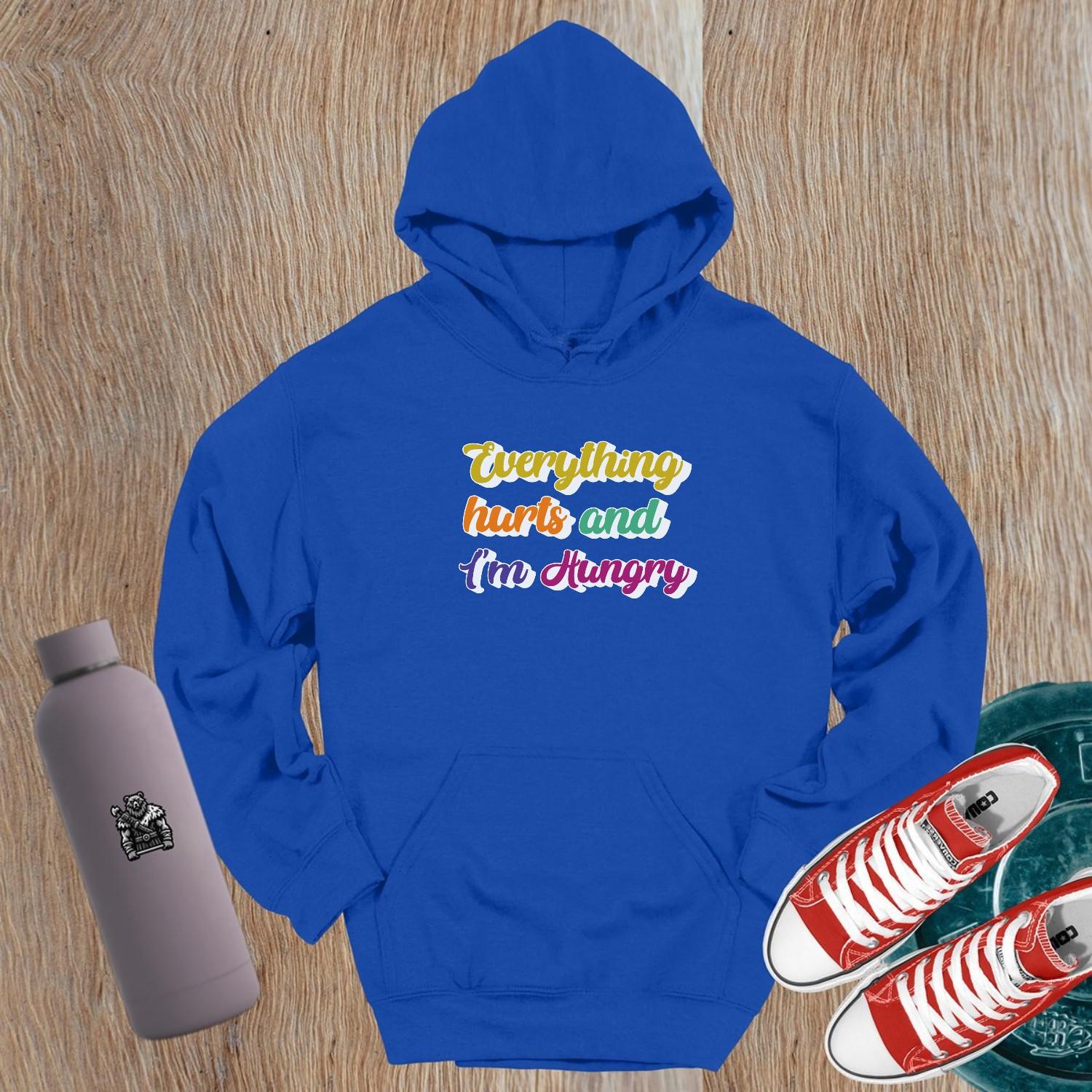 "Vibrant gym hoodie featuring the mantra 'Everything hurts and I'm Hungry,' perfect for workouts and post-gym outings, combining style, comfort, and motivation."