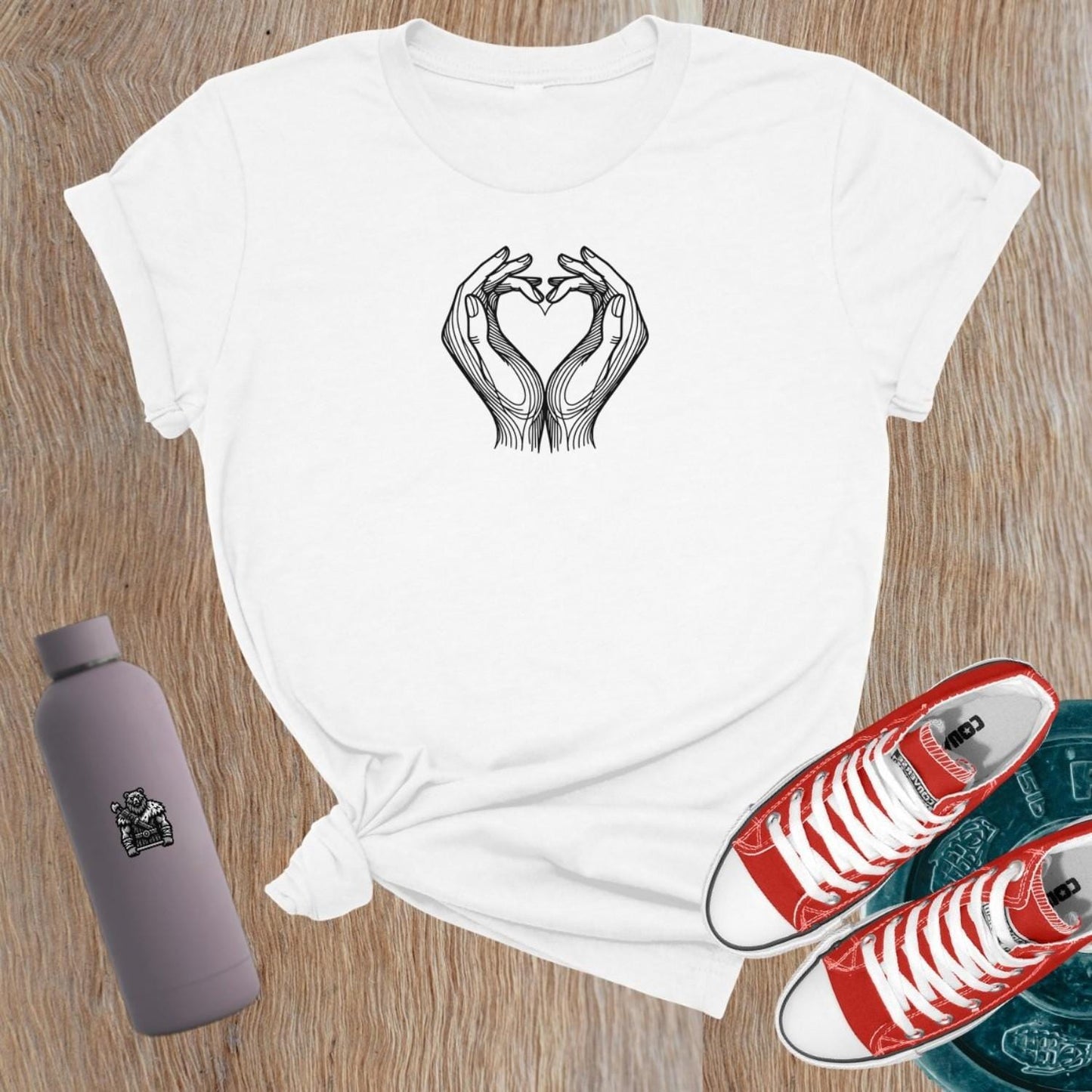 Empowering women's gym T-shirt featuring a heart-shaped hand graphic, symbolizing strength and passion for fitness and lifting weights.