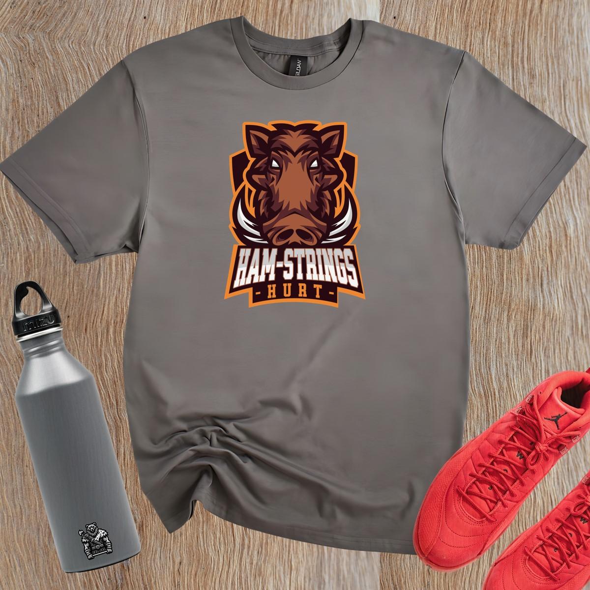 Alt text: "Bold gym T-shirt featuring a fierce wild boar graphic with the text 'Ham-Strings Hurt,' ideal for dedicated fitness enthusiasts."