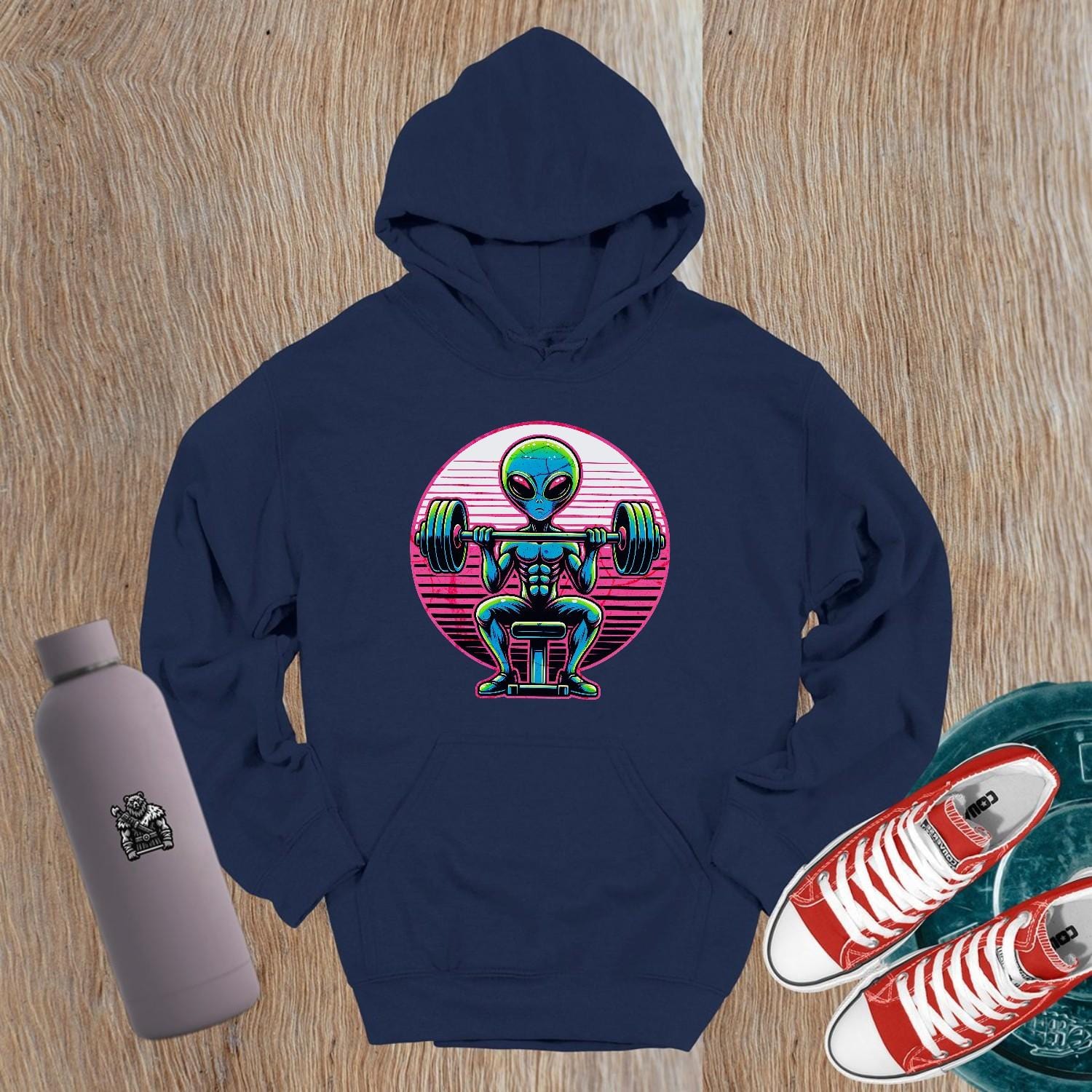 "Vibrant Alien Strength Hoodie featuring a bold alien lifting weights design, perfect for gym enthusiasts seeking unique workout apparel."