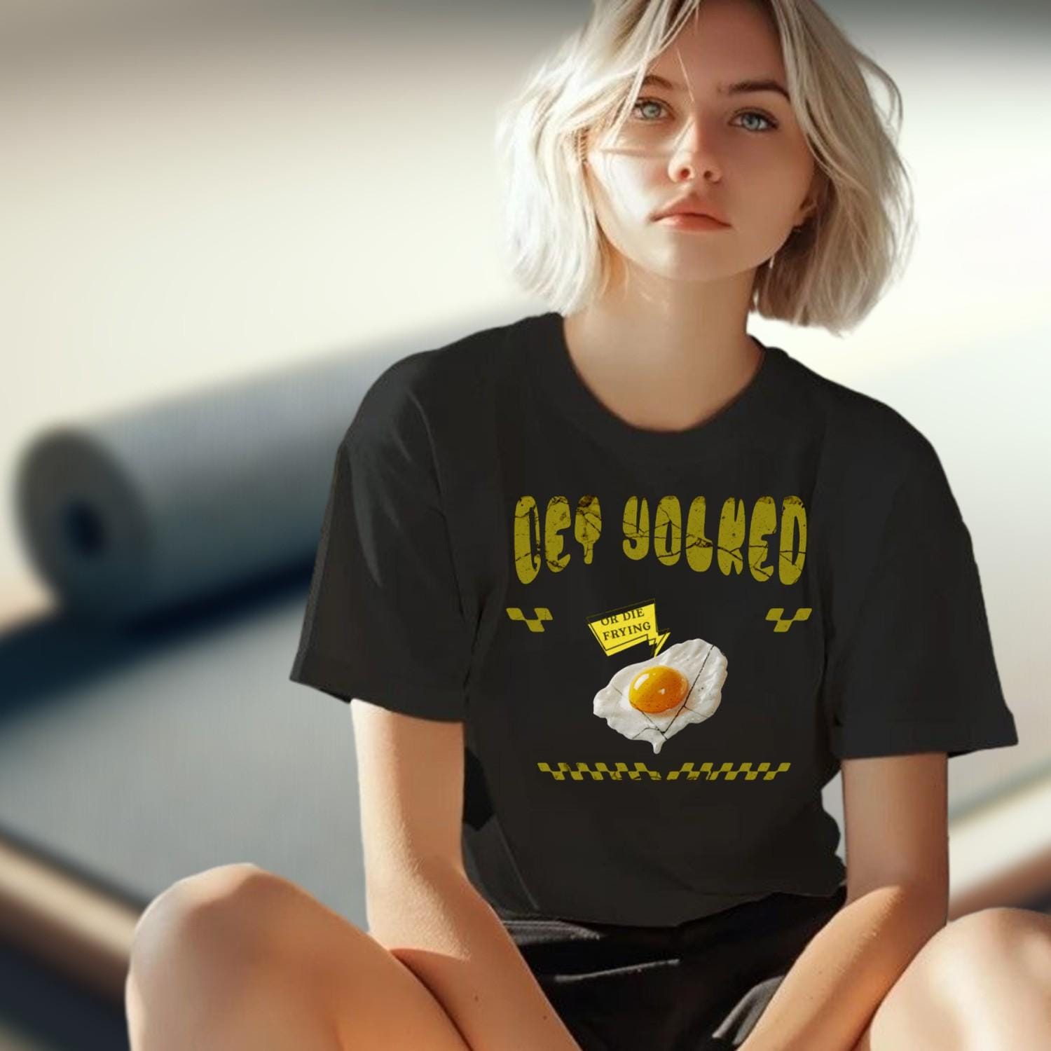 "Bold 'Get Yolked' T-shirt featuring a playful fried egg design, perfect for gym workouts or casual outings. Fitness fashion statement."