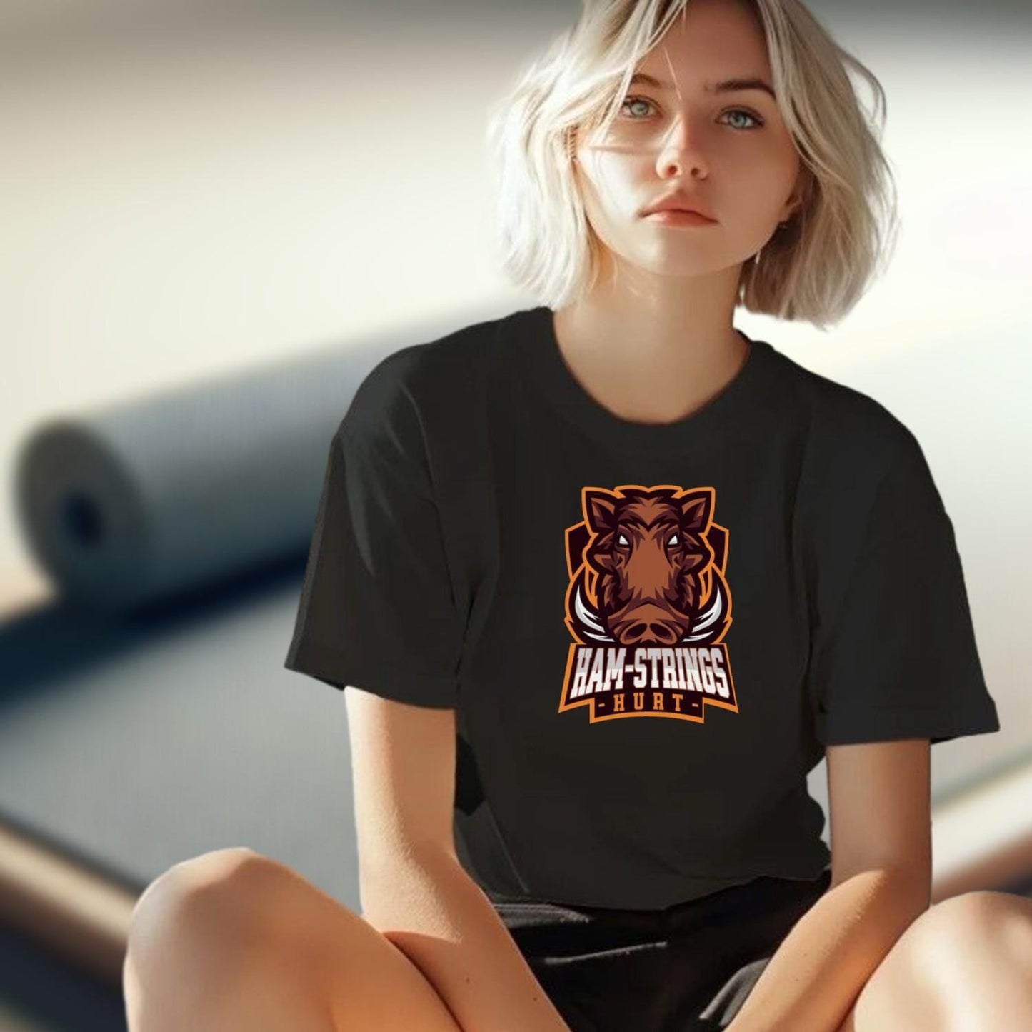 Alt text: "Bold gym T-shirt featuring a fierce wild boar graphic with the text 'Ham-Strings Hurt,' ideal for dedicated fitness enthusiasts."