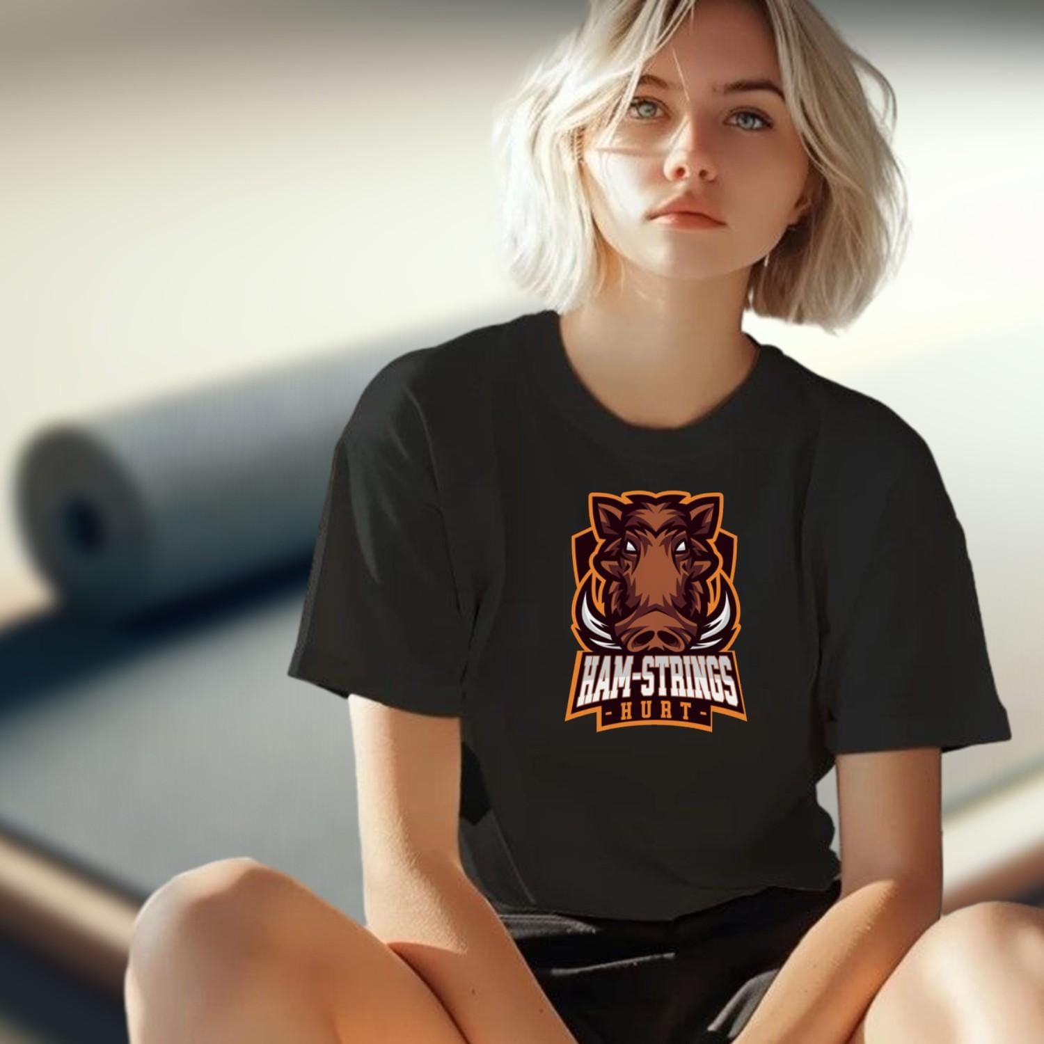 Alt text: "Bold gym T-shirt featuring a fierce wild boar graphic with the text 'Ham-Strings Hurt,' ideal for dedicated fitness enthusiasts."
